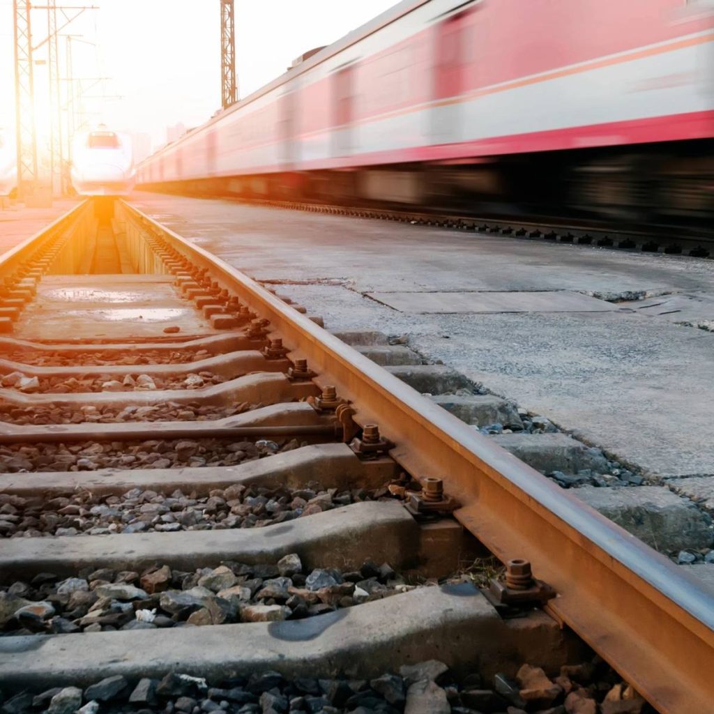 A train is moving down the track in motion.